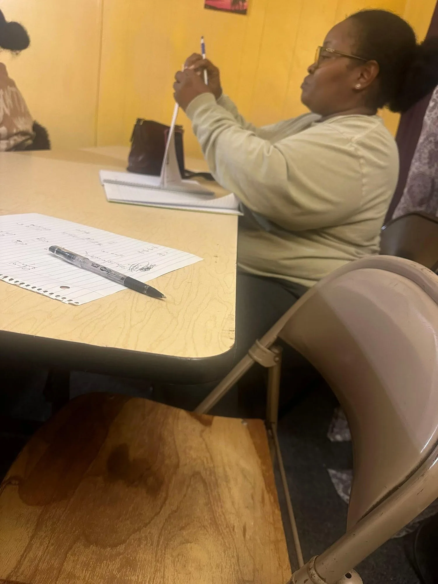 Instructor and adult students actively engaged in a vocational career development workshop discussion