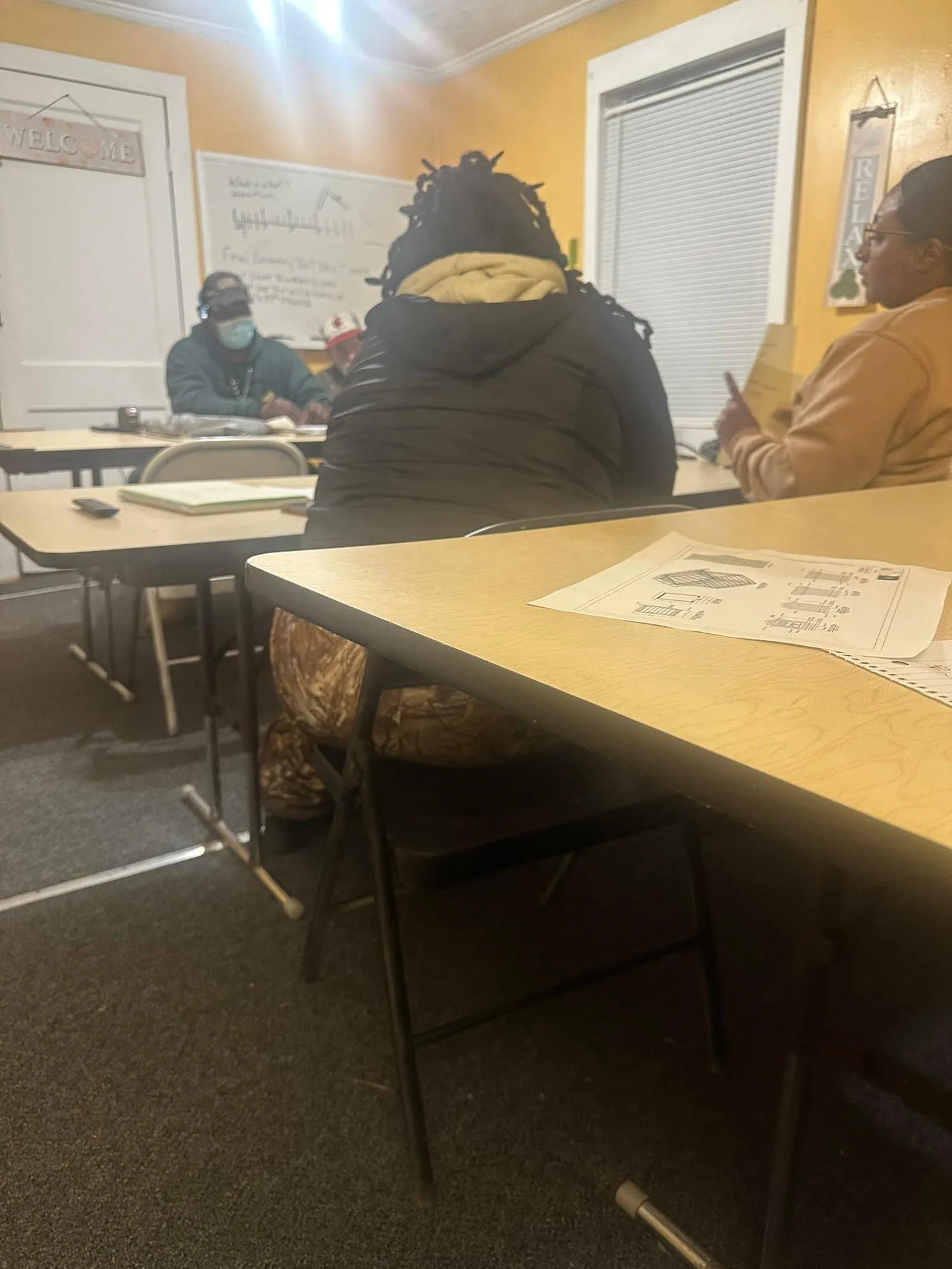 Springboards trainees seated in a classroom reviewing construction blueprints and technical materials